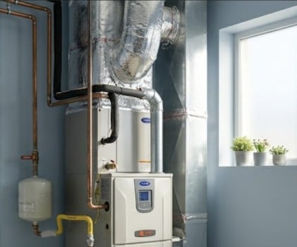 A residential furnace in a clean basement utility room